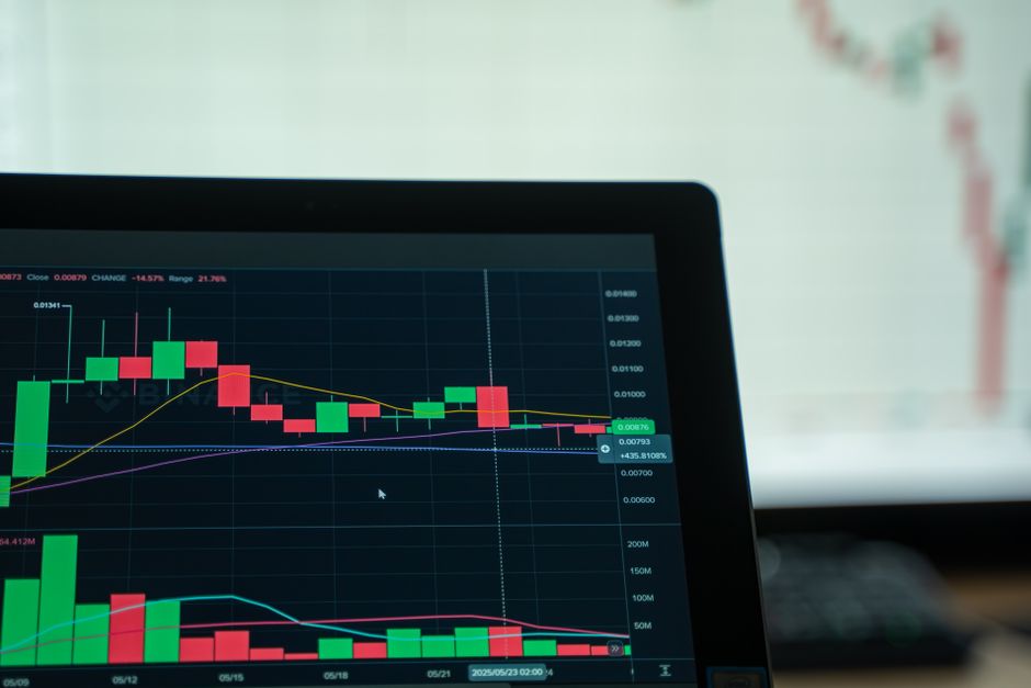 Cryptocurrency analysis on a digital screen with candlestick charts showing market trends and volatility.